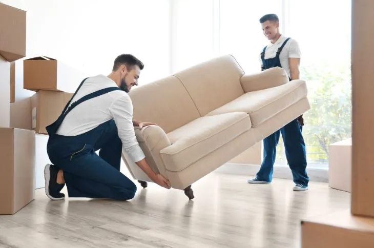 Moving helper placing couch